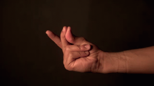 A Close Up Of A Person 'S Hand With Their Fingers Together GIF