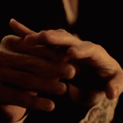 A Close Up Of A Person 'S Hands Folded Together GIF