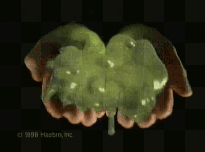 A Close Up Of A Person 'S Hands Holding A Green Substance That Says 1996 Hasbro Inc. GIF