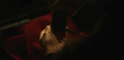A Close Up Of A Person 'S Hands Holding A Pair Of Knitting Needles GIF