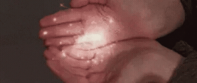 A Close Up Of A Person 'S Hands Holding Something In Their Hands . GIF