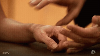 A Close Up Of A Person 'S Hands Touching Each Other . GIF