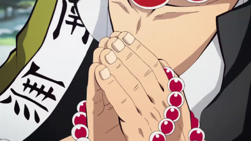 A Close Up Of A Person 'S Hands With Red Beads And Chinese Writing On A Banner GIF