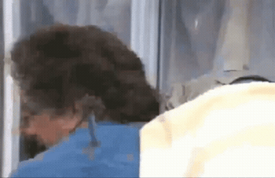 A Close Up Of A Person 'S Head Behind A Glass Door GIF