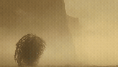 A Close Up Of A Person 'S Head Covered In Sand . GIF