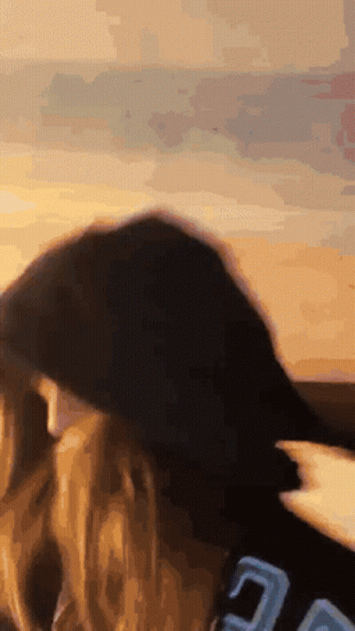 A Close Up Of A Person 'S Head With A Blurred Background GIF