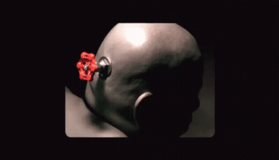 A Close Up Of A Person 'S Head With A Red Object Sticking Out GIF