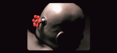 A Close Up Of A Person 'S Head With A Red Object Sticking Out Of It GIF