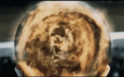 A Close Up Of A Person 'S Head With A Sphere Of Fire Coming Out Of It GIF
