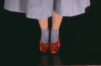 A Close Up Of A Person 'S Legs Wearing A Pair Of Red Shoes GIF