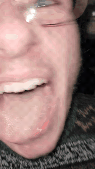 A Close Up Of A Person 'S Mouth With Glasses GIF