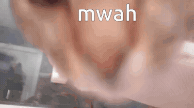 A Close Up Of A Person 'S Mouth With The Word Mwah Written On It GIF