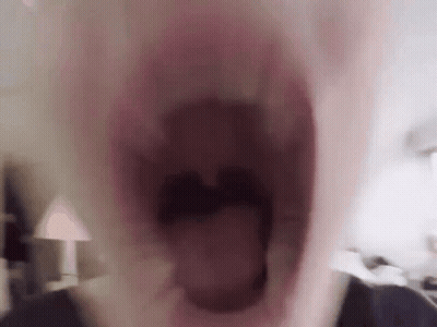 A Close Up Of A Person 'S Mouth With Their Mouth Wide Open GIF