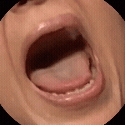 A Close Up Of A Person 'S Mouth With Their Tongue Sticking Out GIF