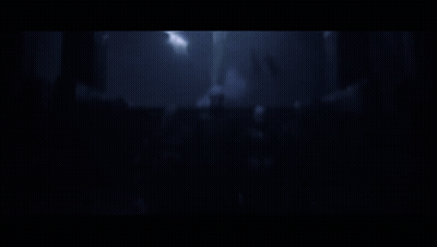 A Close Up Of A Person 'S Neck With A Cage Around It In A Dark Room . GIF