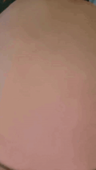 A Close Up Of A Person 'S Stomach With A Black Shirt On . GIF