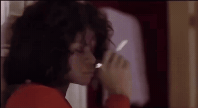 A Close Up Of A Person Smoking A Cigarette In A Bathroom . GIF