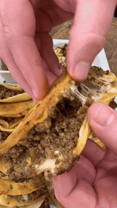 A Close Up Of A Person Taking A Piece Of Food Out Of A Plate GIF