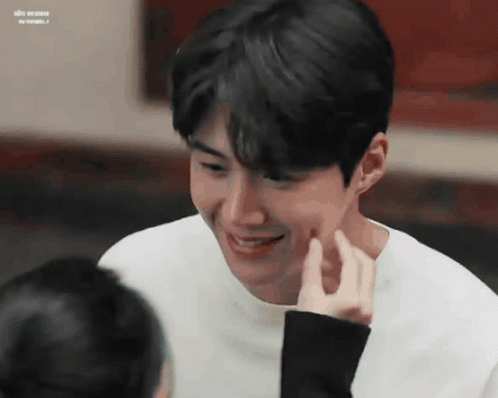 A Close Up Of A Person Touching A Man 'S Face . GIF