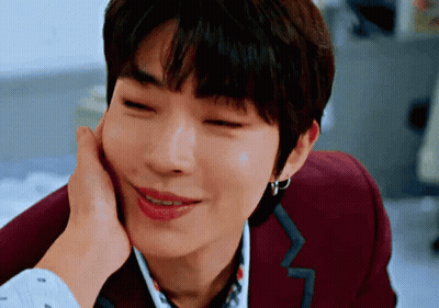 A Close Up Of A Person Touching A Man 'S Face With Their Hand . GIF