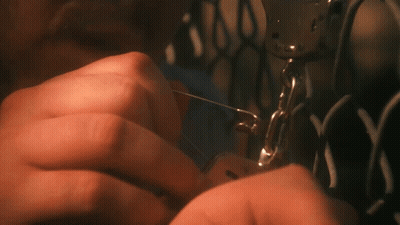 A Close Up Of A Person Using A Sewing Machine With The Letter N On It GIF