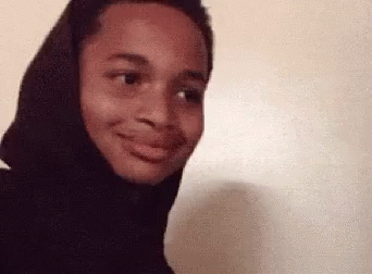 A Close Up Of A Person Wearing A Black Hoodie Making A Funny Face . GIF