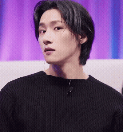 A Close Up Of A Person Wearing A Black Sweater And A Microphone GIF