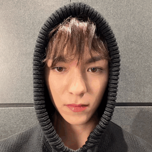 A Close Up Of A Person Wearing A Black Sweater With A Hood GIF