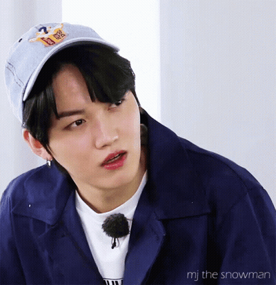 A Close Up Of A Person Wearing A Blue Jacket And A Hat With The Words Mj The Snowman On The Bottom GIF