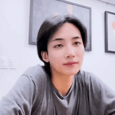 A Close Up Of A Person Wearing A Gray Shirt . GIF