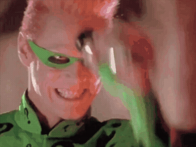 A Close Up Of A Person Wearing A Green Mask And A Green Shirt With A Question Mark On It GIF