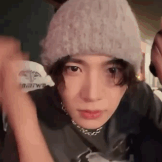 A Close Up Of A Person Wearing A Hat And A Choker . GIF