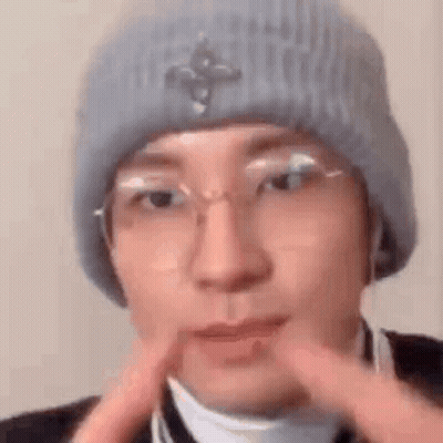 A Close Up Of A Person Wearing A Hat And Glasses . GIF