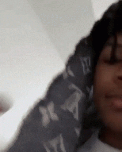 A Close Up Of A Person Wearing A Louis Vuitton Hoodie GIF