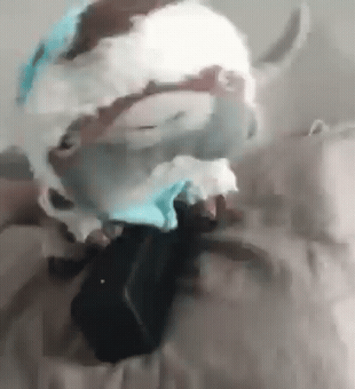 A Close Up Of A Person Wearing A Mask On A Bed . GIF