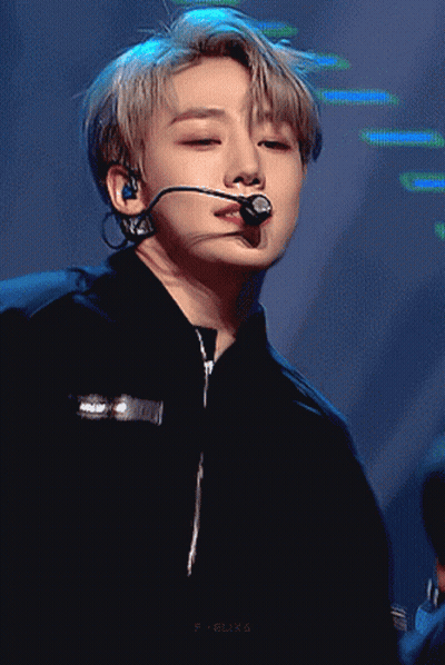 a close up of a person wearing a microphone and a black shirt