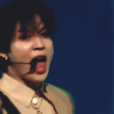 A Close Up Of A Person Wearing A Microphone And A Necklace GIF