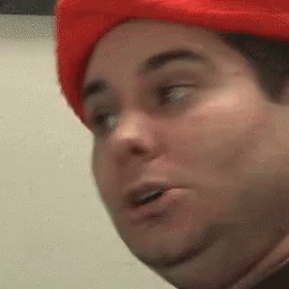A Close Up Of A Person Wearing A Red Hat . GIF