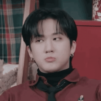 A Close Up Of A Person Wearing A Red Shirt And Tie . GIF