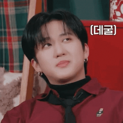 A Close Up Of A Person Wearing A Red Shirt And Tie Making A Funny Face . GIF