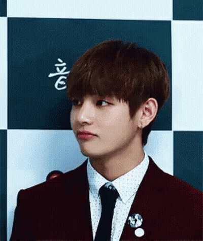 A Close Up Of A Person Wearing A Suit And Tie . GIF