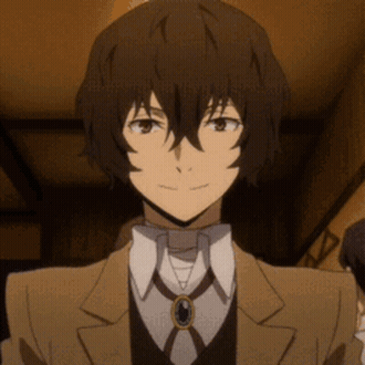 A Close Up Of A Person Wearing A Suit And Tie With A Necklace . GIF