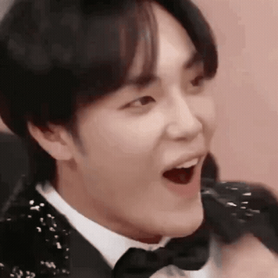 A Close Up Of A Person Wearing A Tuxedo And Bow Tie . GIF