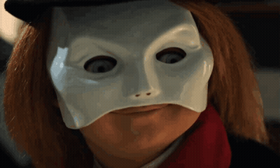 A Close Up Of A Person Wearing A White Mask And A Red Scarf GIF