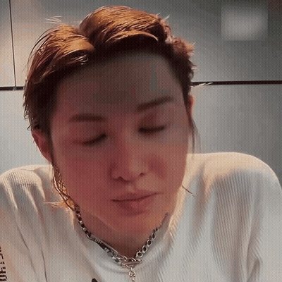 A Close Up Of A Person Wearing A White Shirt And A Chain GIF