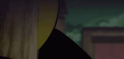 A Close Up Of A Person Wearing A Yellow Hat In A Dark Room GIF