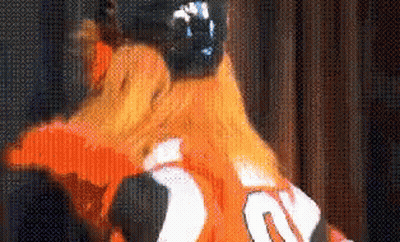 A Close Up Of A Person Wearing An Orange Jersey With The Number 20 On The Back GIF