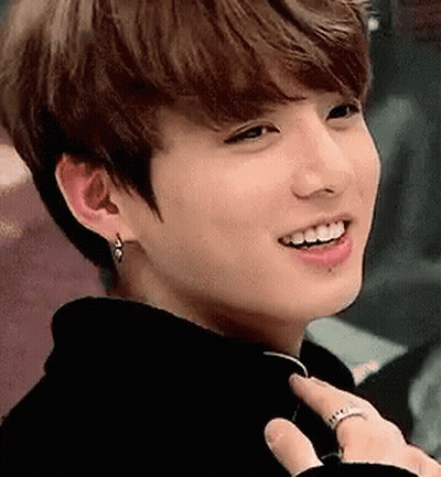 A Close Up Of A Person Wearing Earrings And A Ring . GIF