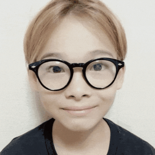 A Close Up Of A Person Wearing Glasses Against A White Background GIF