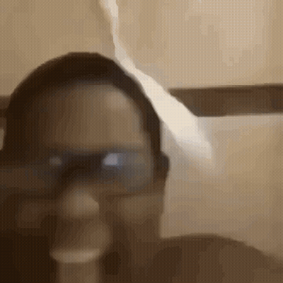 A Close Up Of A Person Wearing Glasses And A Hat In A Bathroom . GIF
